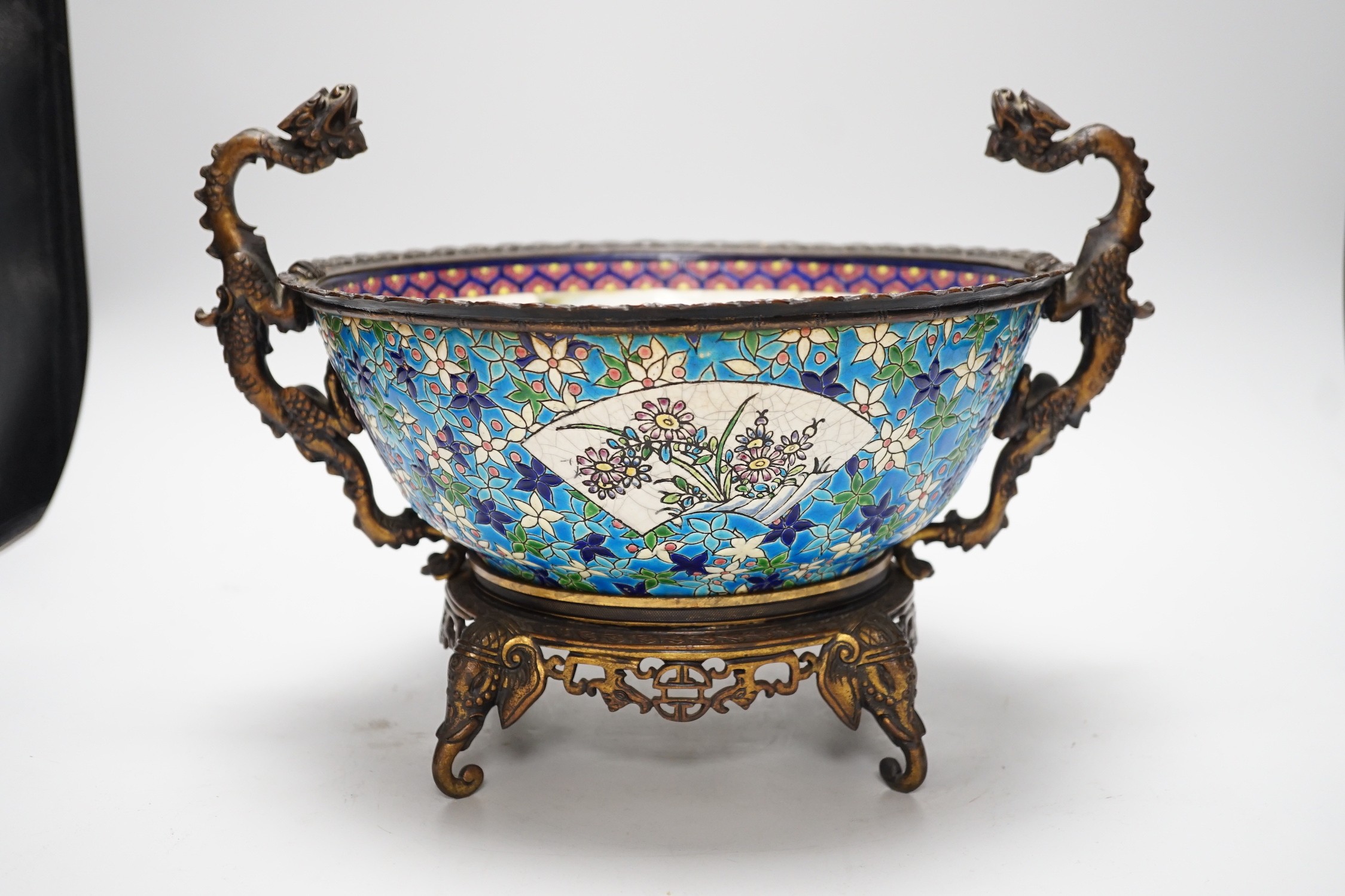 A 19th century French Longwy style ormolu mounted faience bowl on ornate dragon design stand, 23cm high